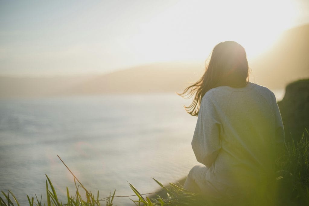 Image of a woman looking out at the ocean