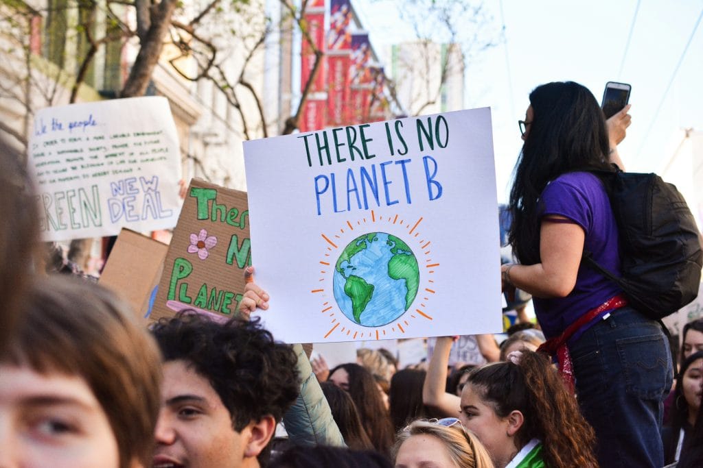 Photo of a climate change protest with a sign that says there is no planet B