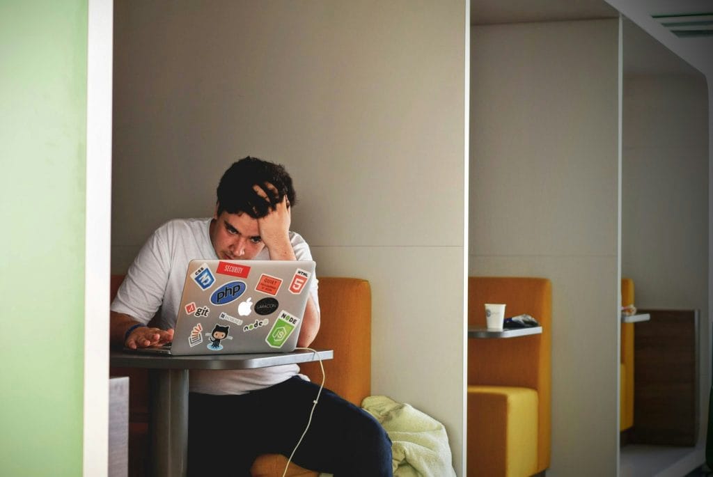 Photo of a man at a desk stressed out